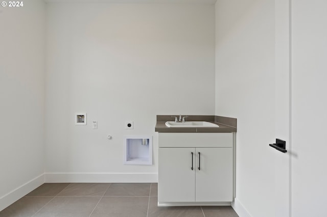 laundry room with cabinets, light tile patterned flooring, sink, electric dryer hookup, and hookup for a gas dryer