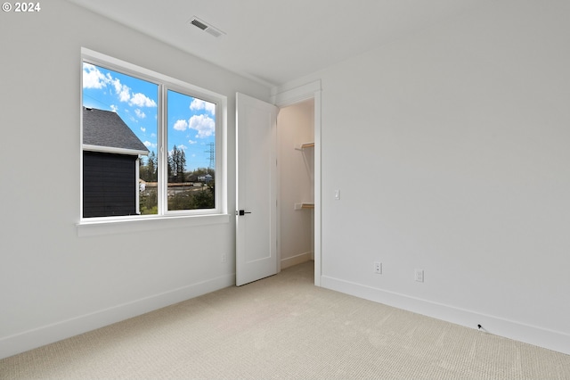 empty room featuring light carpet