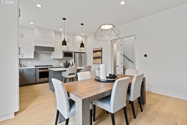 dining space with light wood-type flooring