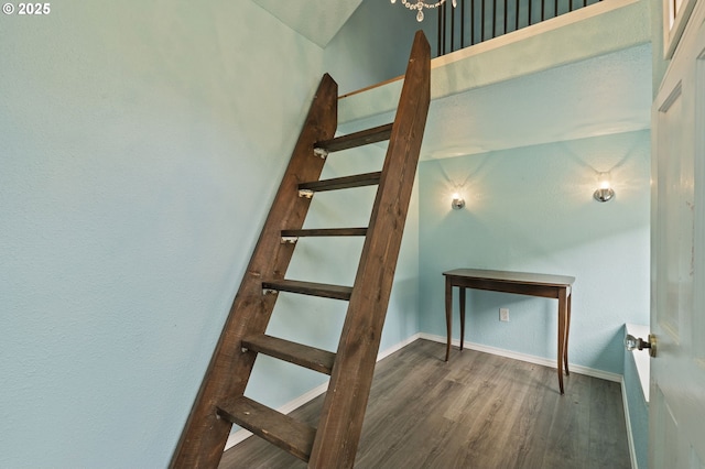 stairs with wood finished floors and baseboards