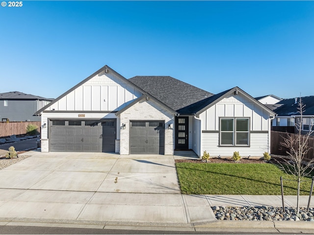 modern farmhouse with a garage and a front lawn