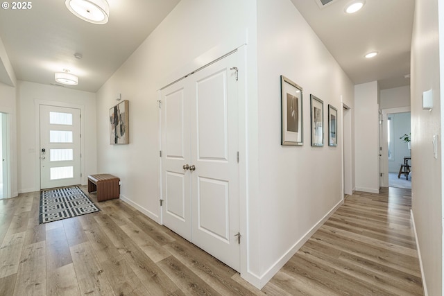 corridor with light hardwood / wood-style flooring