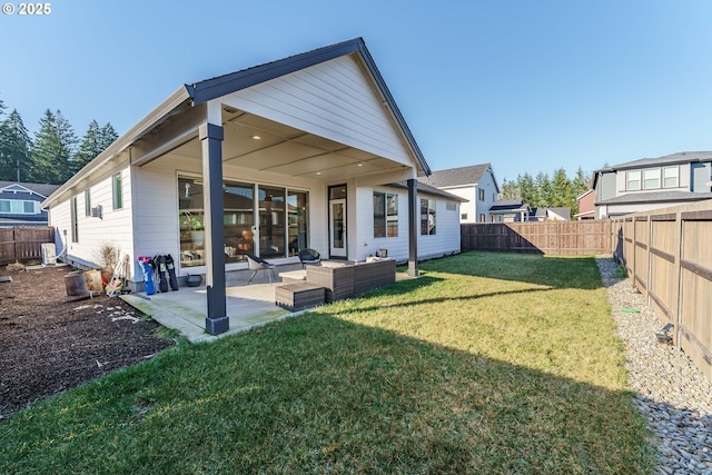 back of house featuring a patio, a yard, and an outdoor hangout area