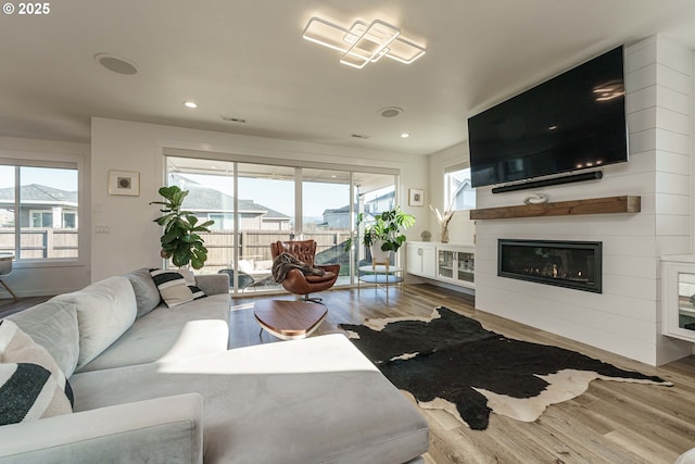 living room featuring hardwood / wood-style flooring and a fireplace