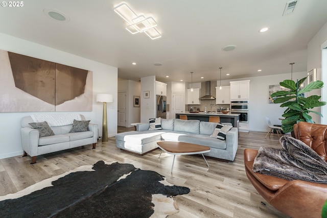 living room with light hardwood / wood-style flooring