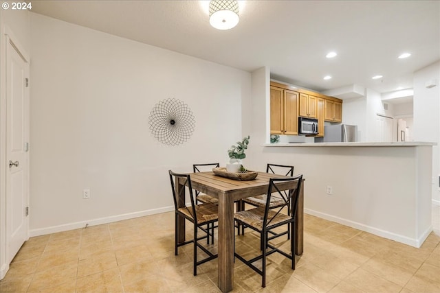 dining room with recessed lighting, baseboards, and light tile patterned floors