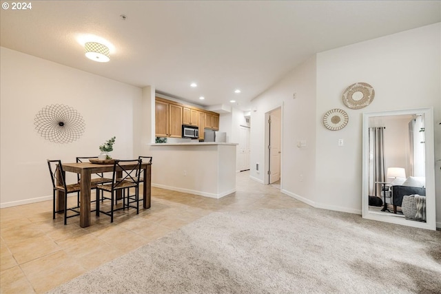 dining space with light tile patterned floors, baseboards, and recessed lighting