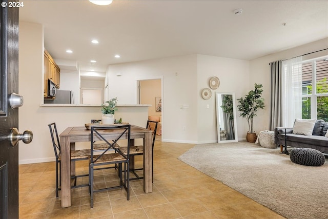 dining space featuring light tile patterned floors