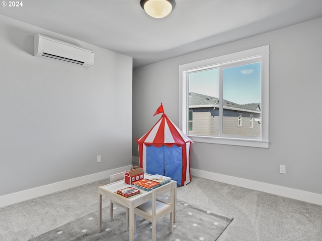 playroom with a wall unit AC, carpet, and baseboards