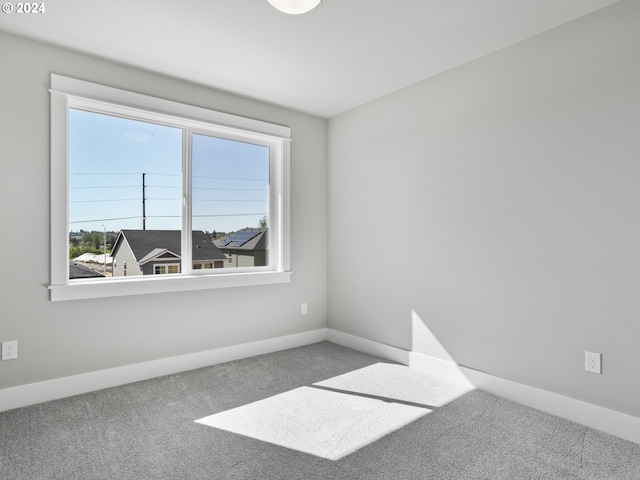 empty room with carpet and baseboards