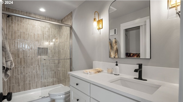 bathroom with vanity, tile patterned flooring, toilet, and walk in shower