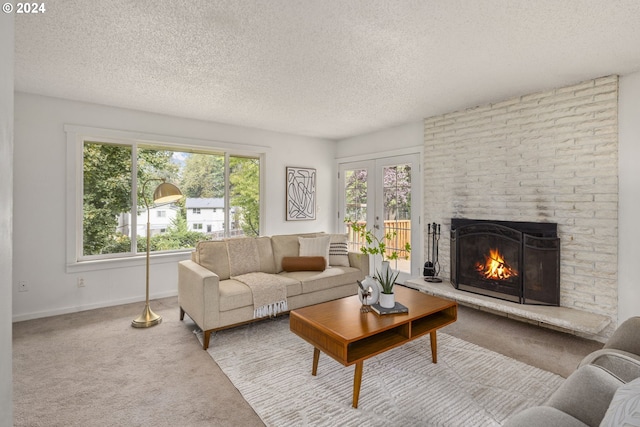 living room with french doors, a fireplace, a textured ceiling, and carpet floors