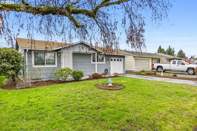 ranch-style home with a garage and a front yard