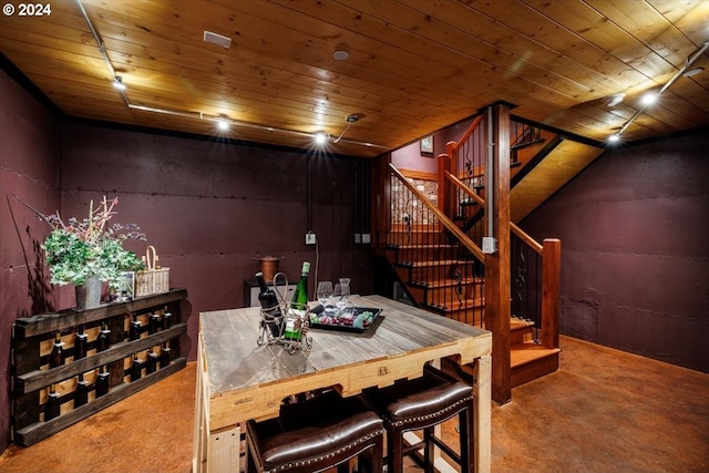 carpeted dining room featuring wooden ceiling