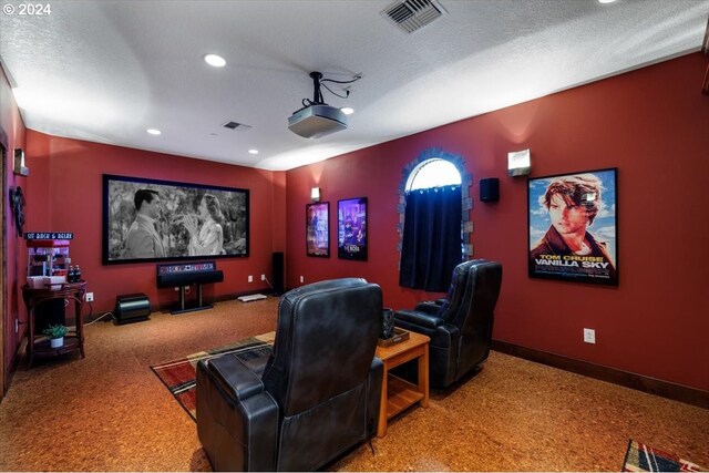 cinema featuring carpet flooring and a textured ceiling