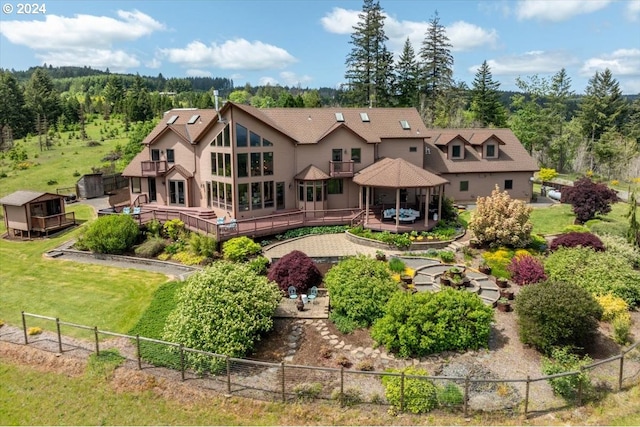 rear view of property featuring a yard and a deck