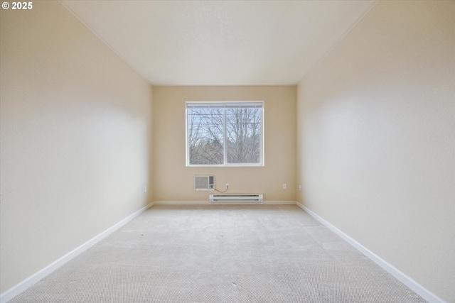 unfurnished room featuring a baseboard heating unit and light colored carpet