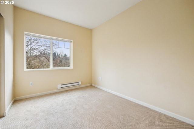 carpeted spare room featuring baseboard heating