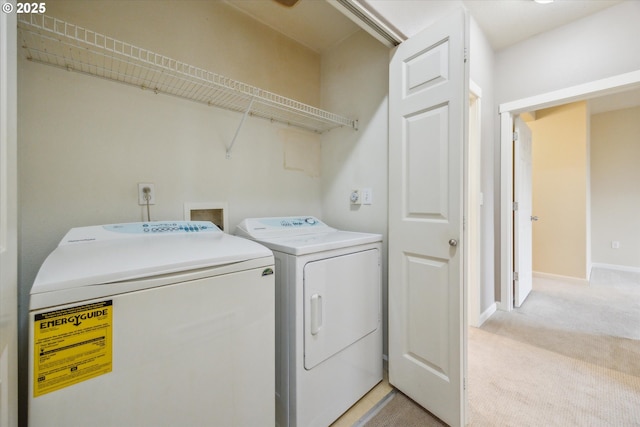 clothes washing area featuring light carpet and washing machine and dryer