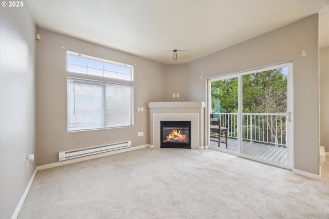 unfurnished living room featuring light carpet, baseboard heating, a wealth of natural light, and a tiled fireplace