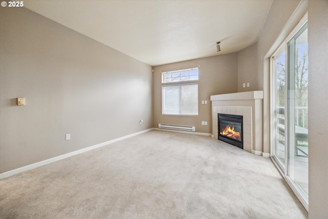 unfurnished living room featuring light carpet, a tiled fireplace, and a baseboard radiator