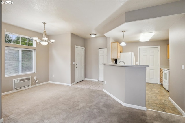 kitchen with decorative light fixtures, white appliances, a wall mounted air conditioner, light brown cabinets, and light carpet