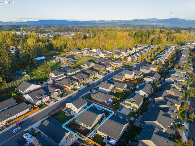 birds eye view of property with a mountain view