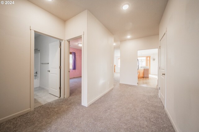 hallway with light colored carpet