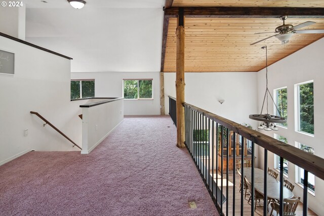 hallway with wood ceiling, carpet, beamed ceiling, and high vaulted ceiling