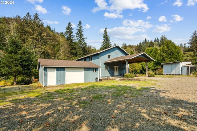 view of front of property with an outdoor structure and a garage