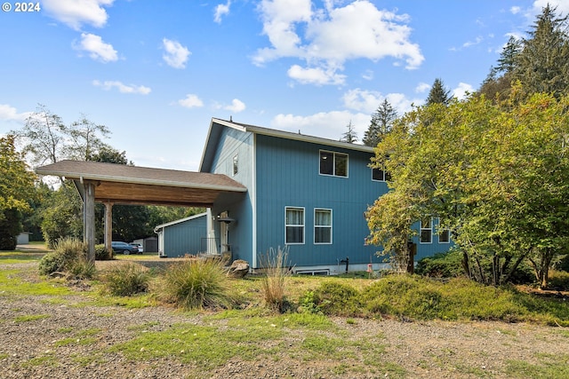 rear view of house featuring a carport