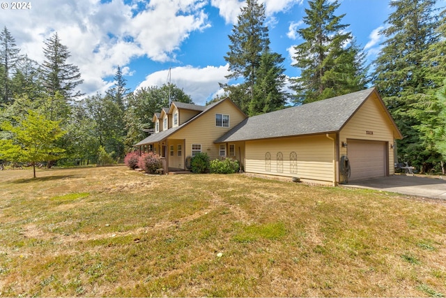 view of front of home with a front lawn and a garage