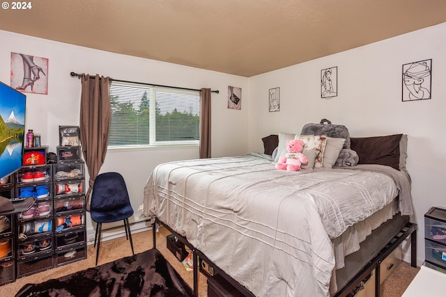 carpeted bedroom featuring a baseboard heating unit