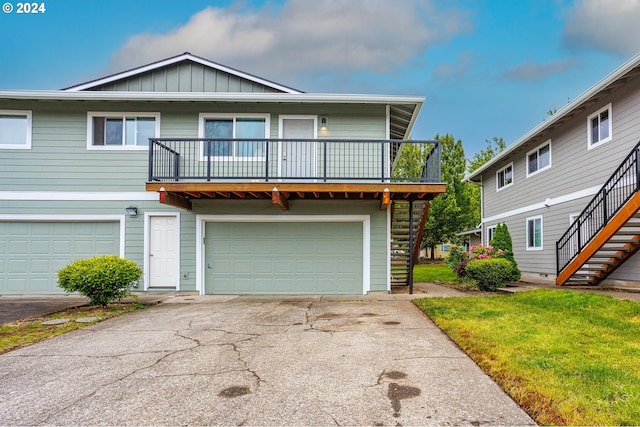 view of front of home featuring a balcony and a garage