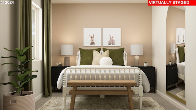 bedroom featuring light carpet and baseboards