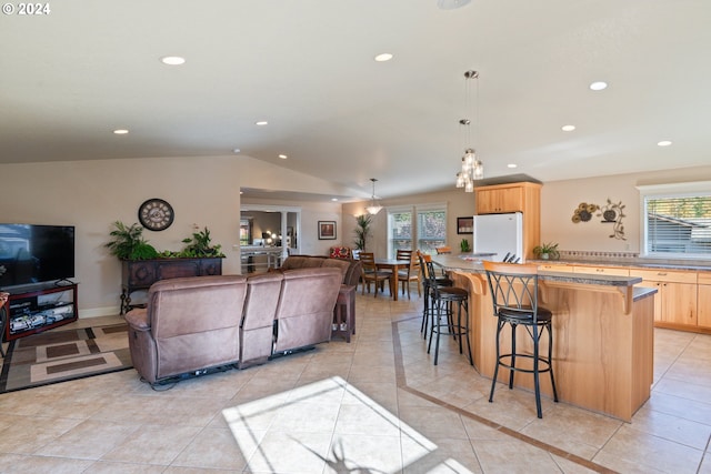 interior space with lofted ceiling and light tile patterned floors