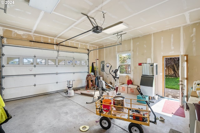 garage with a garage door opener and electric panel