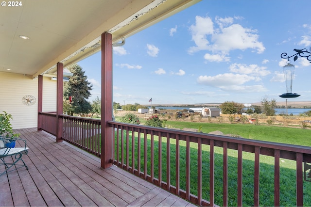 wooden deck with a lawn