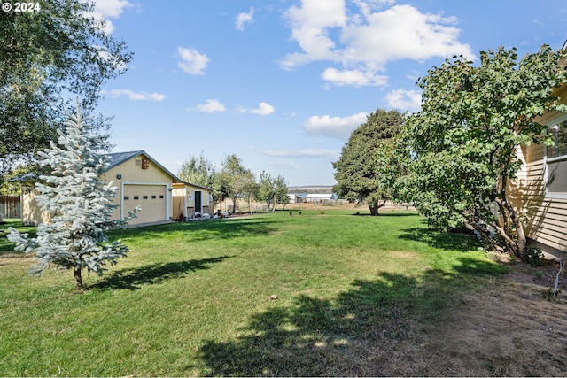 view of yard with an outdoor structure and a garage