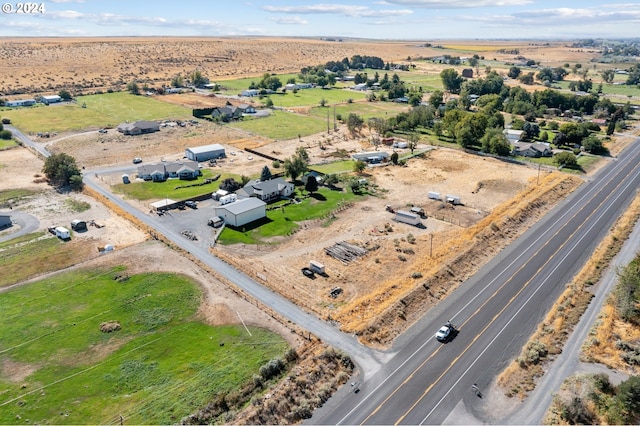 birds eye view of property with a rural view