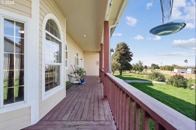 deck featuring a yard and a porch