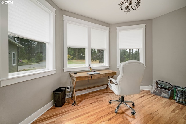 home office with wood finished floors, baseboards, and a chandelier