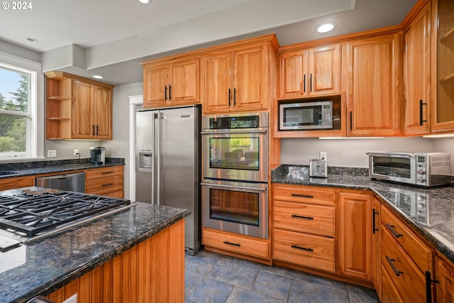 kitchen with open shelves, stainless steel appliances, dark stone countertops, and recessed lighting