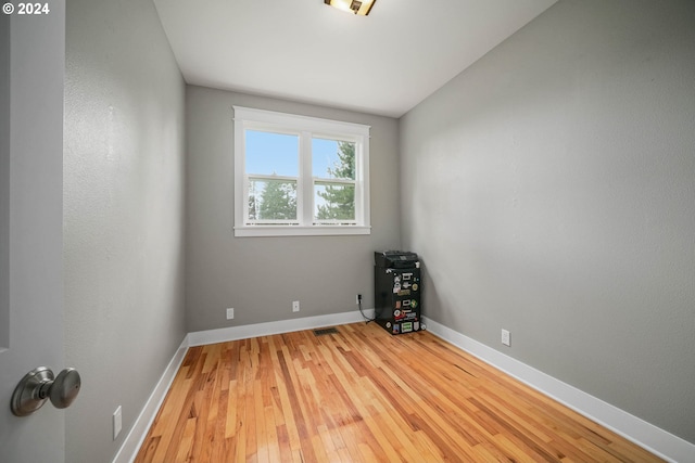 unfurnished room featuring light wood-type flooring and baseboards