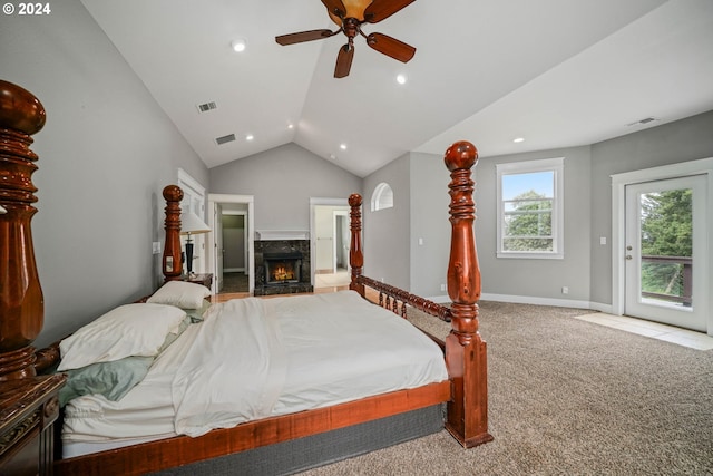 carpeted bedroom with access to exterior, ceiling fan, a premium fireplace, and vaulted ceiling