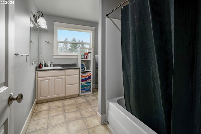 bathroom featuring baseboards, shower / bath combination with curtain, vanity, and tile patterned flooring