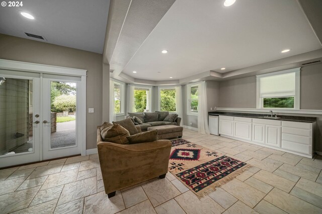 living room with french doors and sink