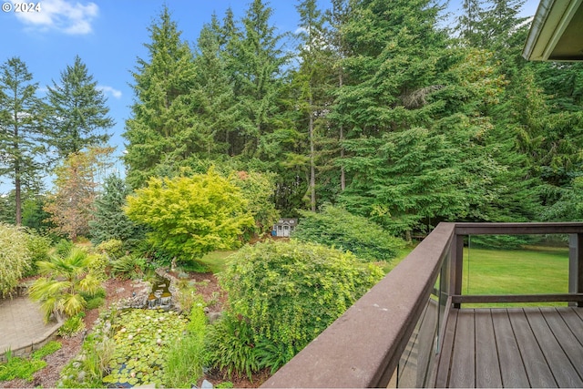 wooden terrace featuring a lawn