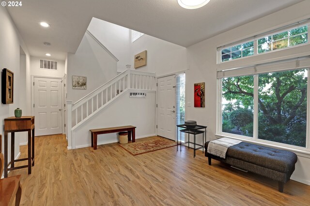 bedroom with lofted ceiling, light carpet, and ensuite bathroom