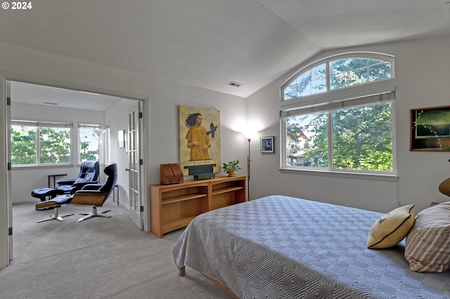 bedroom featuring light carpet, multiple windows, and lofted ceiling